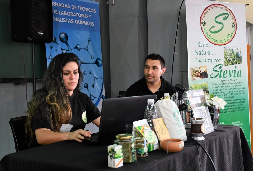 La pareja dicta una charla en una jornada de técnicos de laboratorios, presentando sus productos. 